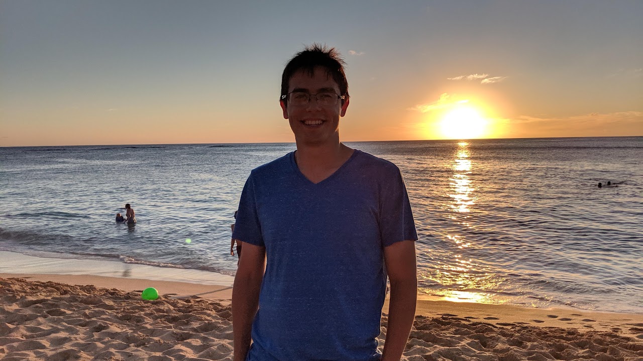 Joel Villatoro on a beach at sunset